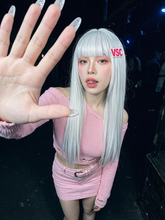 Wan 2.7 Image selfie-style club portrait with white wig styling and direct camera framing